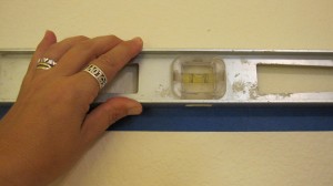 Use level to make sure tape is as straight as possible for Step 2